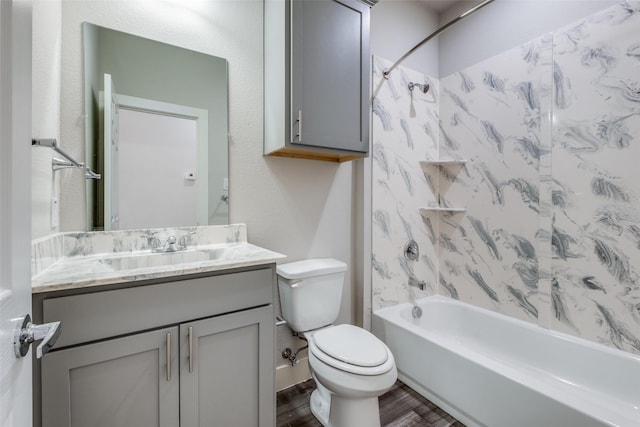 full bathroom with shower / bath combination, vanity, wood-type flooring, and toilet