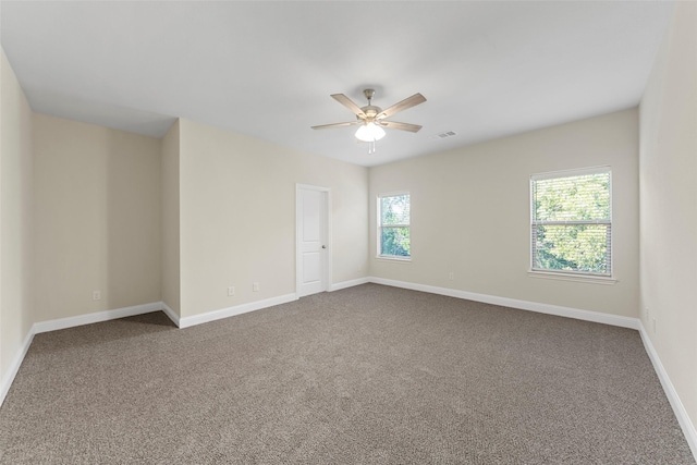 unfurnished room featuring ceiling fan and carpet