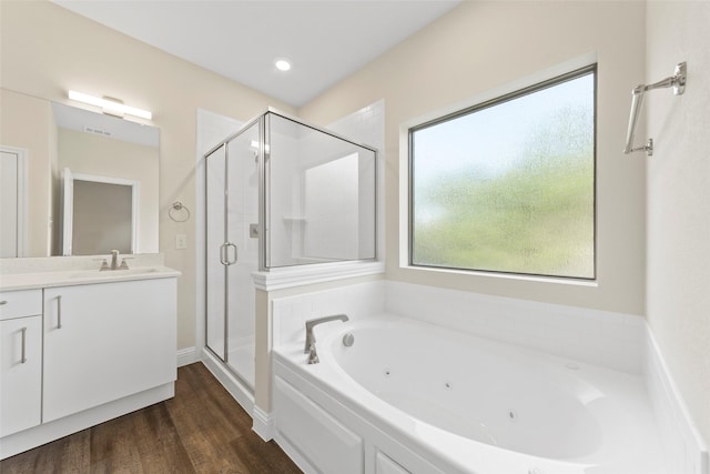 bathroom featuring independent shower and bath, vanity, and hardwood / wood-style floors