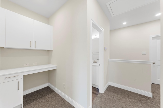 hallway featuring dark colored carpet