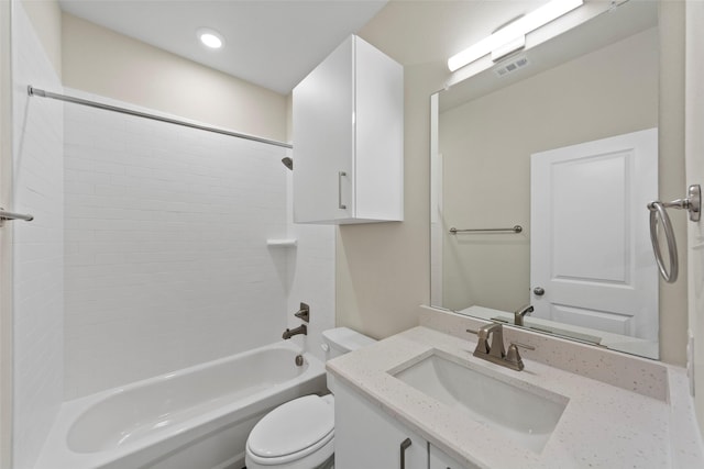 full bathroom with tiled shower / bath combo, vanity, and toilet