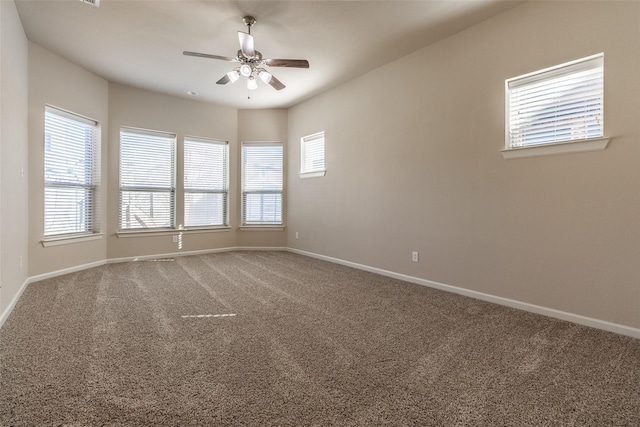 spare room with ceiling fan and carpet