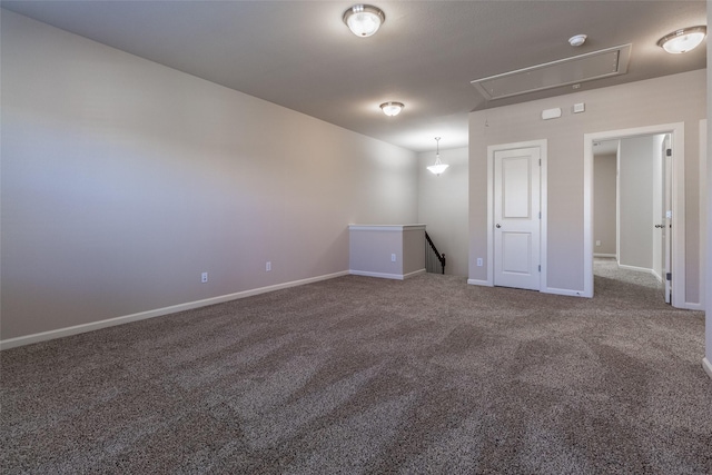 unfurnished room featuring dark colored carpet