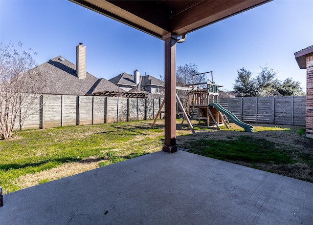 view of yard with a patio and a playground