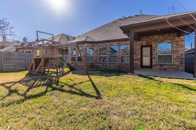 back of property featuring a playground, a patio, and a yard