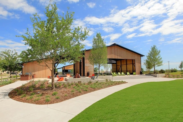 view of front facade with a front yard and a fire pit