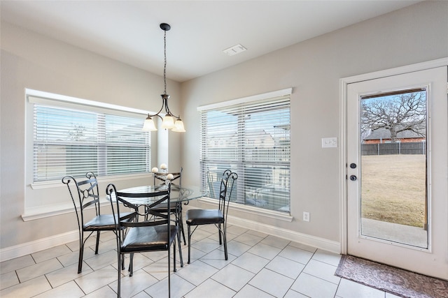 dining space featuring light tile patterned flooring