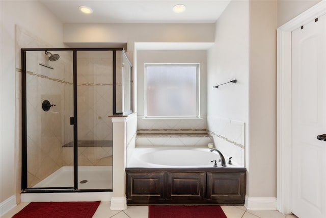 bathroom featuring tile patterned floors and separate shower and tub