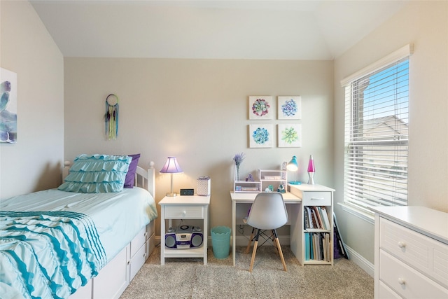 bedroom featuring lofted ceiling and light carpet