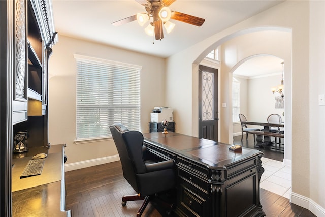 home office with dark wood-type flooring and ceiling fan