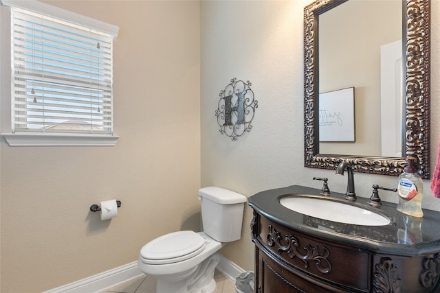 bathroom with vanity, tile patterned floors, and toilet