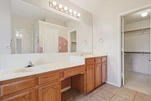 bathroom with vanity, tile patterned flooring, and a textured ceiling