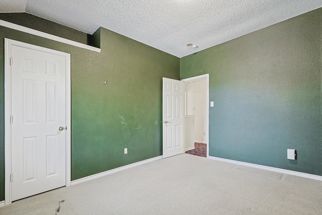 unfurnished bedroom featuring carpet and a textured ceiling