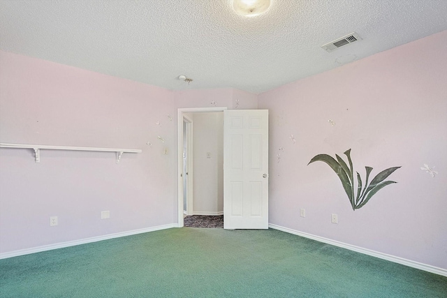 unfurnished room featuring dark carpet and a textured ceiling