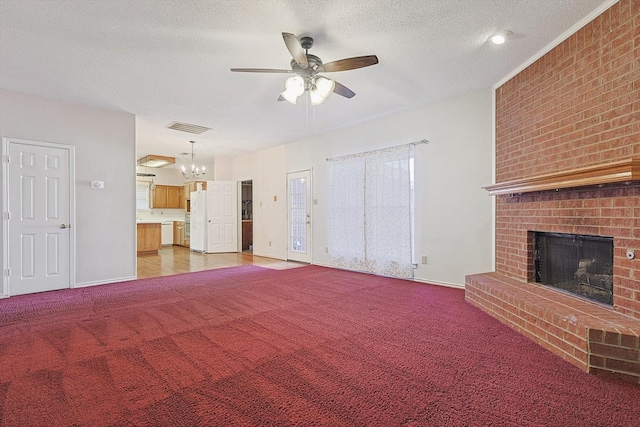 unfurnished living room with ceiling fan, a fireplace, carpet flooring, and a textured ceiling