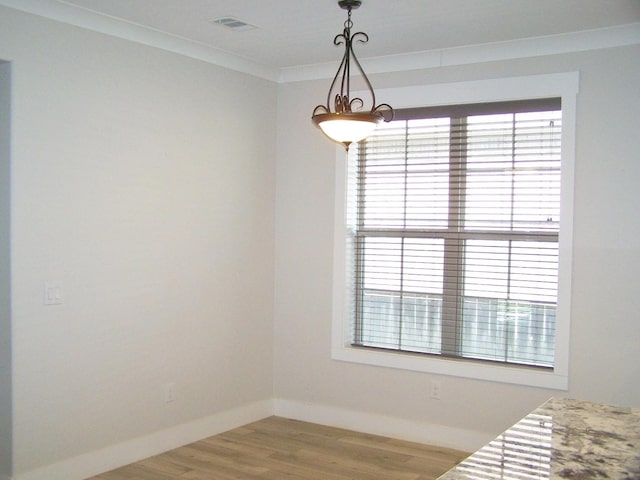 bedroom featuring multiple windows, crown molding, and hardwood / wood-style flooring