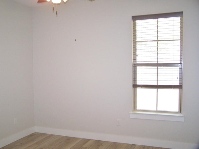 empty room featuring hardwood / wood-style flooring and ceiling fan