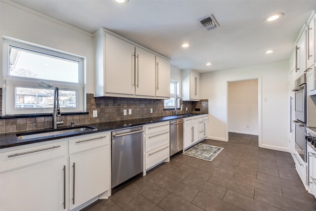 unfurnished living room featuring a chandelier, recessed lighting, a sink, and wood finished floors