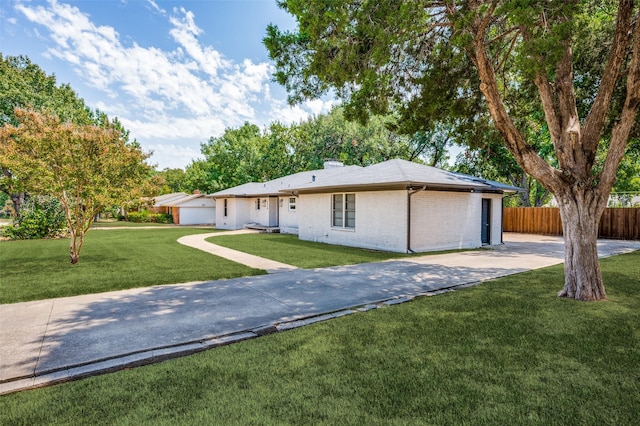 ranch-style home with a garage and a front lawn