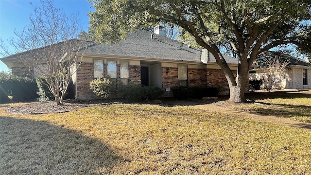 ranch-style home with a front lawn