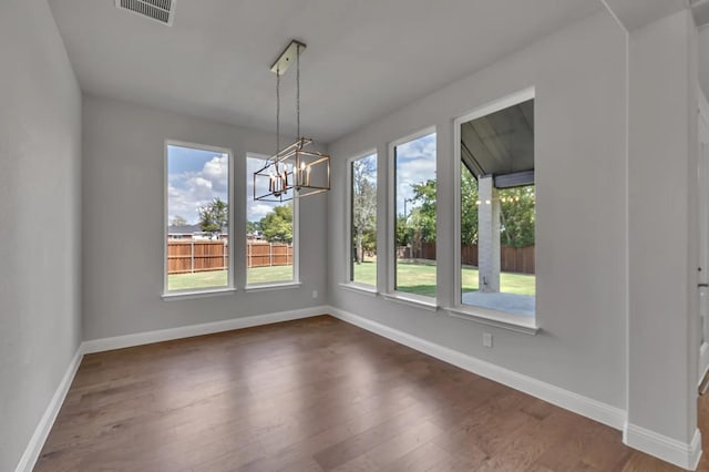 2301 Hawk Meadow Ct, Mansfield, TX 76063 - unfurnished dining area featuring dark wood-type flooring and a chandelier