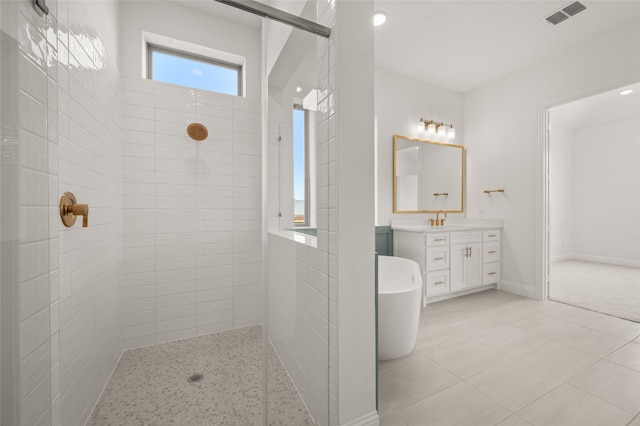2301 Hawk Meadow Ct, Mansfield, TX 76063 - bathroom with a walk in shower, vanity, a freestanding tub, and tile patterned flooring