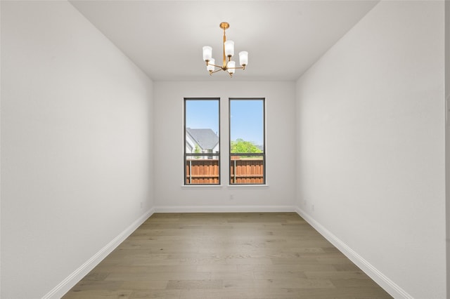 2301 Hawk Meadow Ct, Mansfield, TX 76063 - empty room with a chandelier and light wood-type flooring