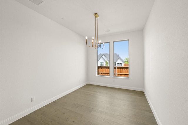 2301 Hawk Meadow Ct, Mansfield, TX 76063 - spare room with a chandelier and wood finished floors