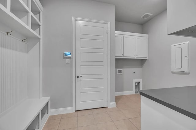 2301 Hawk Meadow Ct, Mansfield, TX 76063 - laundry room with electric dryer hookup, cabinet space, light tile patterned floors, and hookup for a washing machine