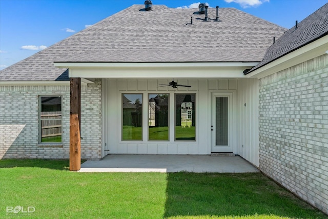 back of property with a lawn, ceiling fan, and a patio area