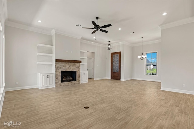 unfurnished living room with crown molding, ceiling fan with notable chandelier, a fireplace, and light wood-type flooring