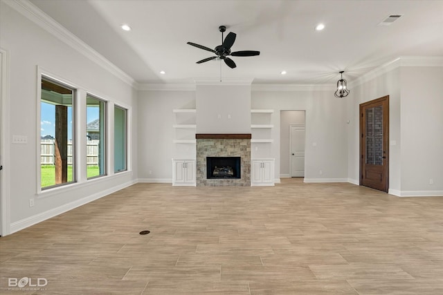 unfurnished living room featuring ornamental molding, light wood-type flooring, ceiling fan, and a fireplace