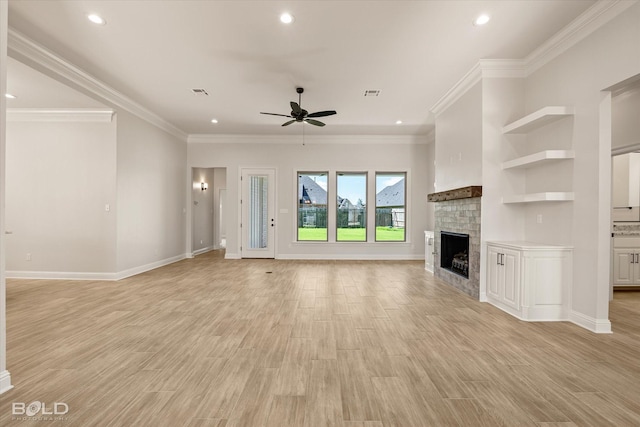 unfurnished living room featuring crown molding, a fireplace, light hardwood / wood-style floors, and ceiling fan