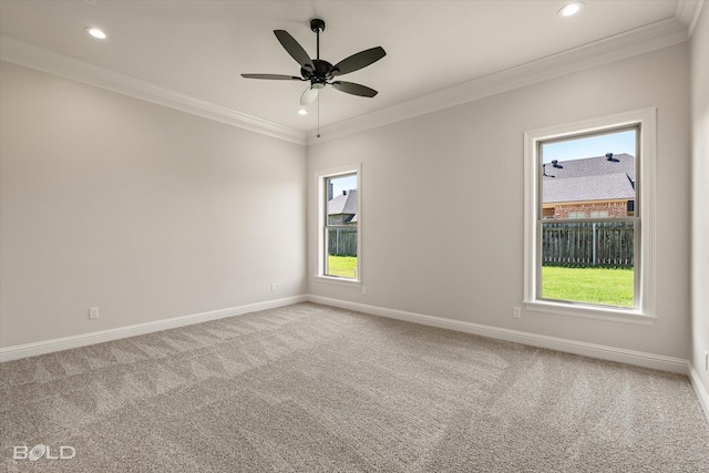 carpeted empty room featuring ornamental molding, a wealth of natural light, and ceiling fan