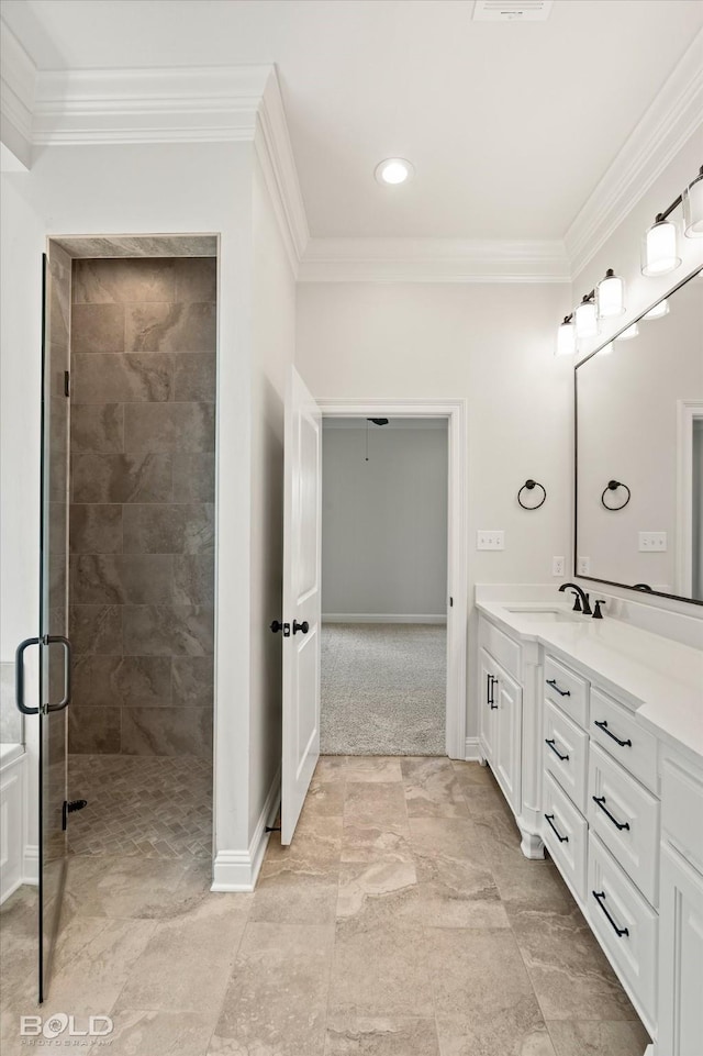 bathroom with crown molding, vanity, and a shower with door