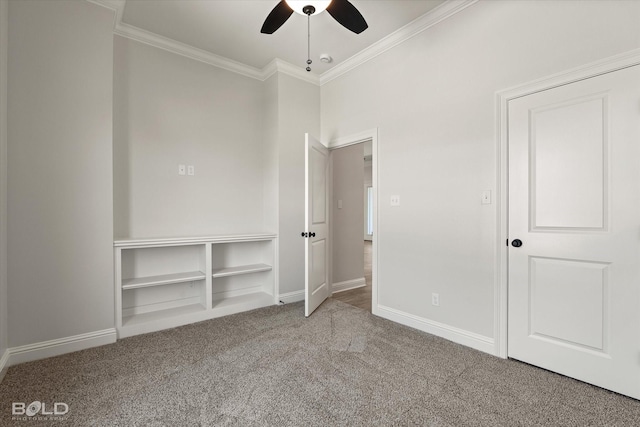 unfurnished bedroom with crown molding, carpet floors, and ceiling fan