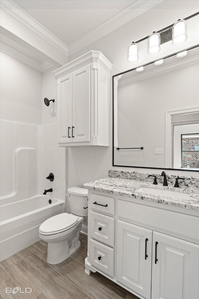 full bathroom with hardwood / wood-style flooring, vanity, ornamental molding, shower / washtub combination, and toilet