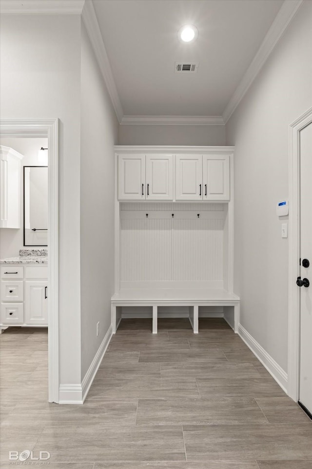 mudroom featuring ornamental molding and light hardwood / wood-style floors