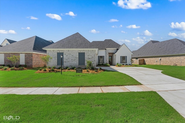 french country inspired facade featuring a front lawn