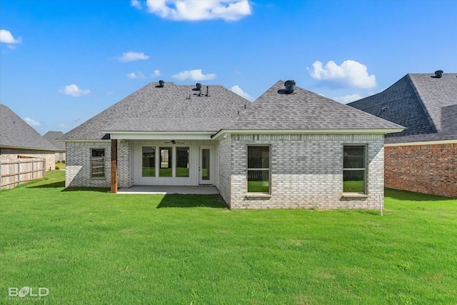 back of house with ceiling fan, a patio, and a lawn