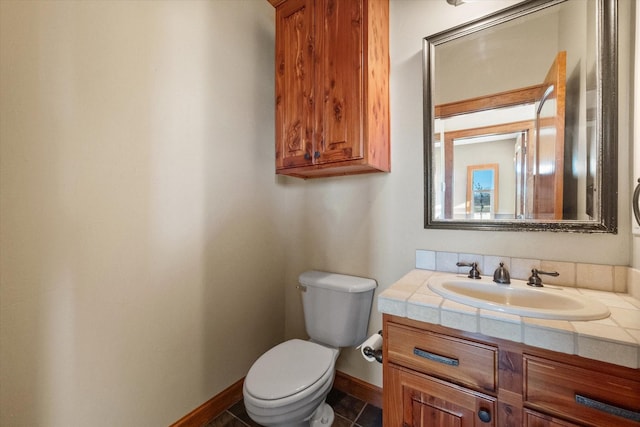 bathroom with vanity, tile patterned flooring, and toilet