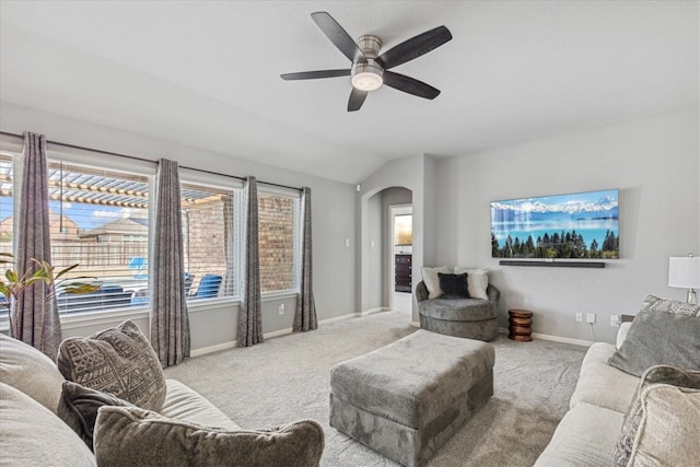 carpeted living room featuring vaulted ceiling and ceiling fan