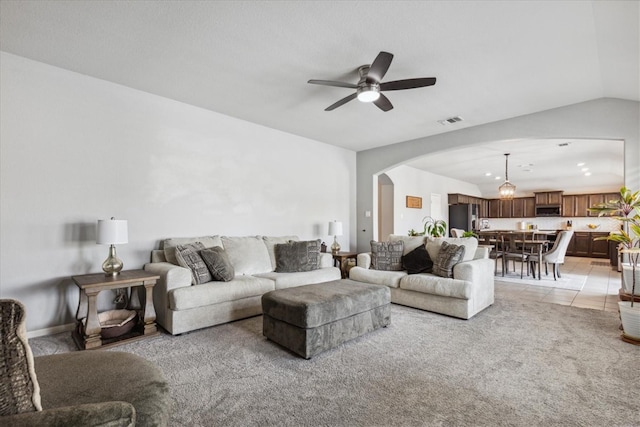 living room with vaulted ceiling, light tile patterned floors, and ceiling fan