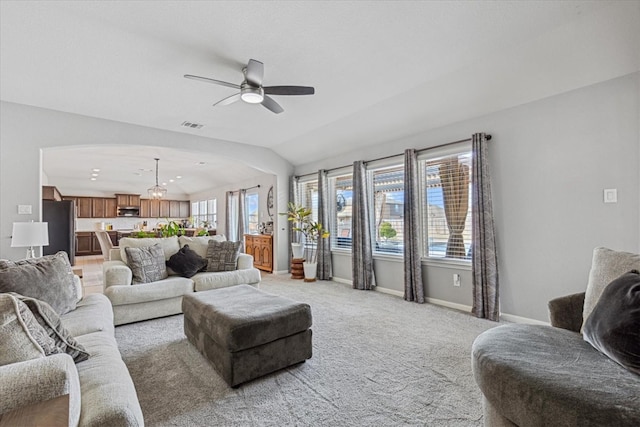 living room featuring vaulted ceiling, light colored carpet, and ceiling fan