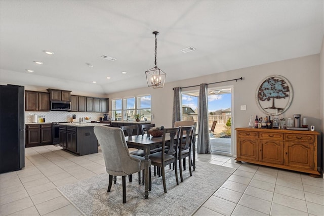 tiled dining area featuring a notable chandelier