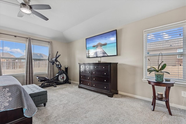 carpeted bedroom featuring multiple windows, lofted ceiling, and ceiling fan