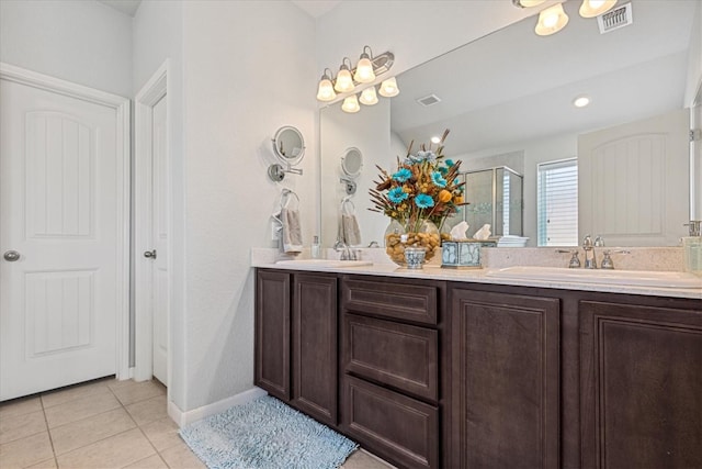 bathroom with tile patterned flooring, vanity, and an enclosed shower