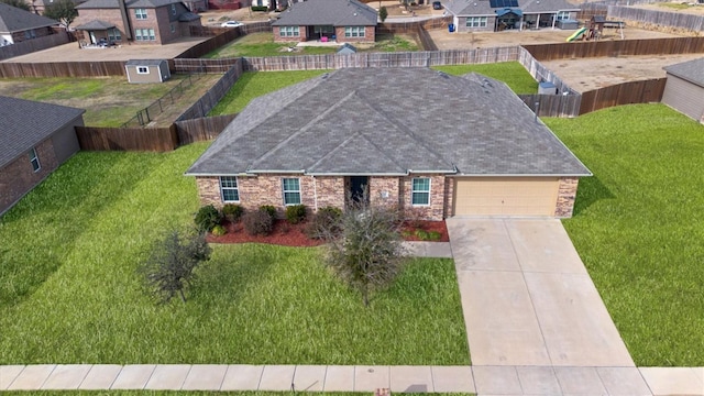 view of front of house with a garage and a front lawn