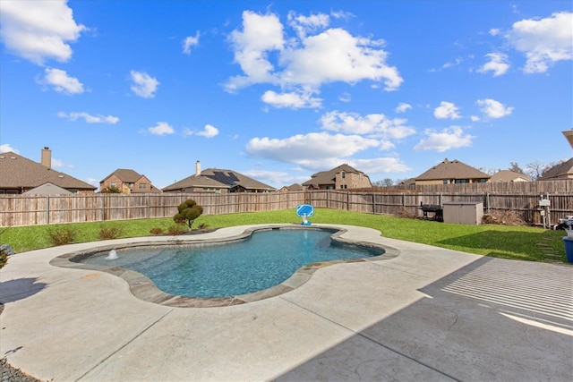 view of pool with a patio and a lawn