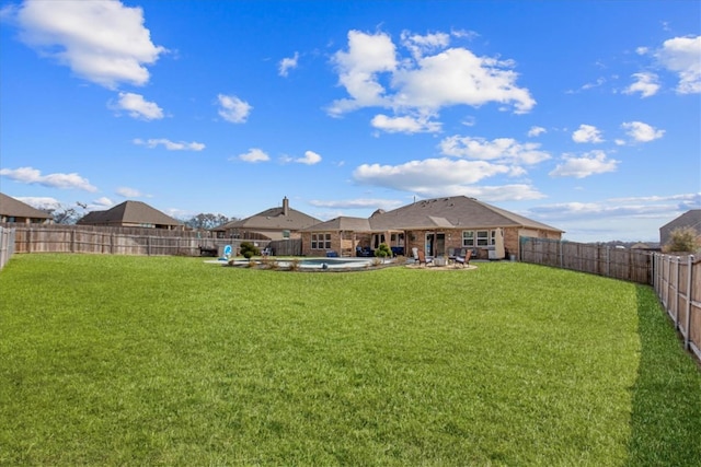 view of yard with a fenced in pool and a patio area